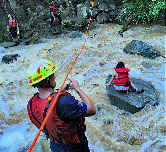 Stranded person is rescued after quick rising waters trapped her midstream.
