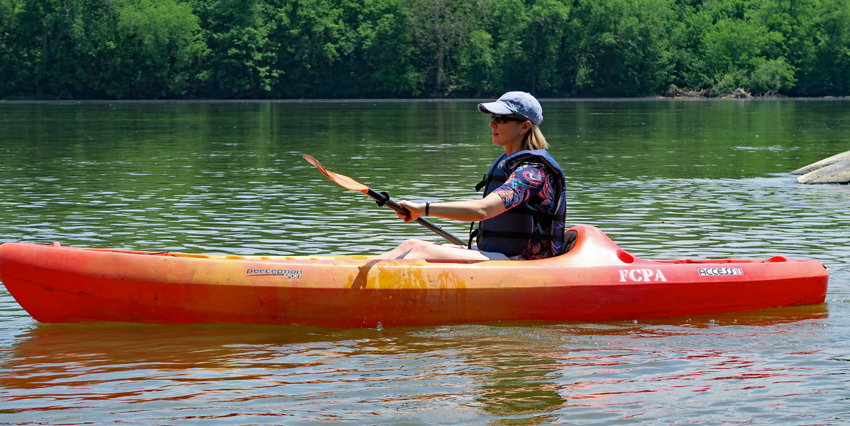 A woman kayaks on the Potomac River at Riverbend Park